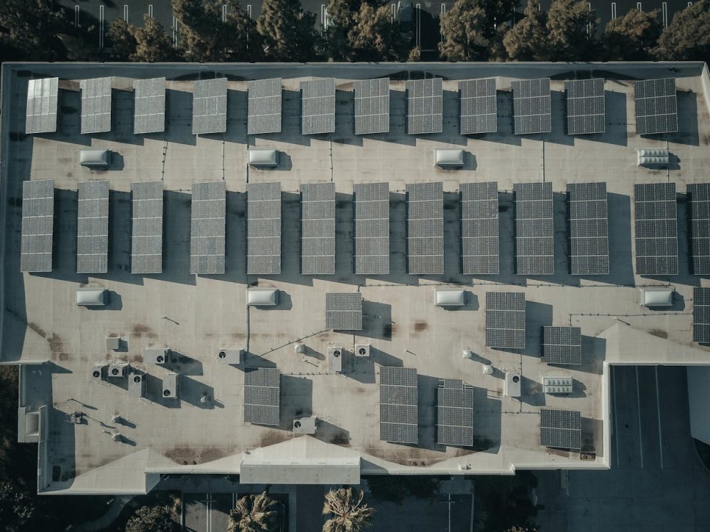 Discover the efficiency of solar energy with this aerial shot of solar panels on a rooftop.