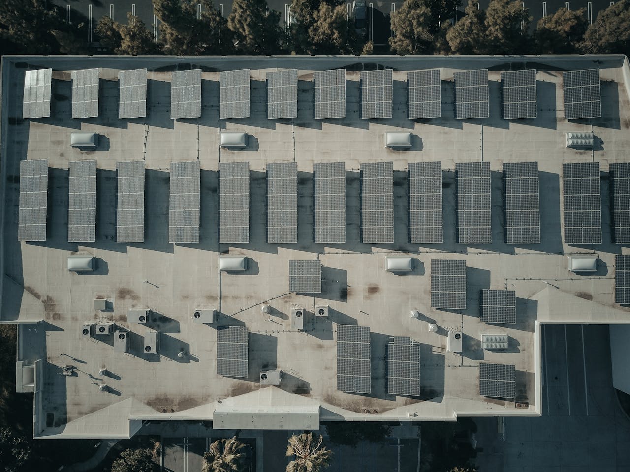 Discover the efficiency of solar energy with this aerial shot of solar panels on a rooftop.